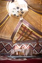 Kazak yurt interior with traditional felt carpets and furniture