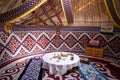 Kazak yurt interior with traditional felt carpets and furniture