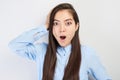 Kazakh Asian shocked girl student in glasses with mouth open surprised has an idea on white studio background Royalty Free Stock Photo