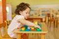 Kazakh curly girl playing in kids development center