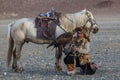 Kazakh Eagle Hunter traditional clothing, while hunting to the hare holding a golden eagle on his arm Royalty Free Stock Photo