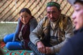 Kazakh family of hunters with hunting birds golden eagles inside the mongolian Yurt.