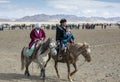 Kazakh family traveling on their horses