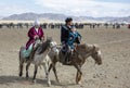 Kazakh family traveling on their horses