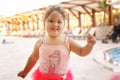 Kazakh little girl playing near swimming pool