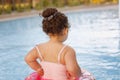 Kazakh little girl playing near swimming pool