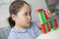 Kazakh pretty little girl playing in kids development center