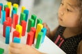 Kazakh pretty little girl playing in kids development center