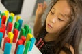 Kazakh pretty little girl playing in kids development center