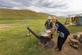 Kazakh nomadic woman cooking in Assy Plateau, Kazakhstan.