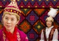 Local women and man in traditional clothes at national folkloric games in Almaty, Kazakhstan.