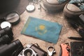 Kazakhstan Flag Between Traveler`s Accessories on Old Vintage Map. Tourist Destination Concept