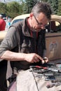 Kazakhstan, Kostanay, 19-06-19, Rally Peking to Paris. The driver of a retro car is holding repair tools. Mechanic in glasses with