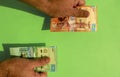 Kazakhstan national currency. Money banknotes. Man hands hold kazakh tenge banknotes on green background