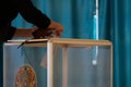 Kazakhstan, Qazaqstan, June 9, 2019, Elections, voting, A woman in the voting hall puts the ballot in a transparent box with the