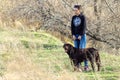 Young women walking with dog brown chocolate labrador retriever outdoor