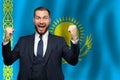 Kazakhstani happy businessman on the background of flag of Kazakhstan Business, education, degree and citizenship concept Royalty Free Stock Photo