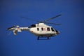 White Russian medical helicopter ANSAT in flight against a blue sky