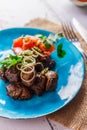 Kazan kebab with vegetables on a blue plate Royalty Free Stock Photo