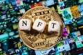 The word NFT non-fungible token is laid out of cubes with letters and golden cryptocoin on background Beeple digital art EVERYDA