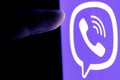 The finger reaches for Viber instant messaging service logo on smartphone screen