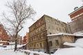 Kazan, Russia, 10 february 2017, Winter russian courtyard - old ramshackle russian house - boy cleans snow