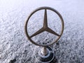 Kazan, Russia - January 2, 2021: Mercedes logo. The logo on the car. The car is covered with white snow. It a sign. Transport,