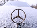 Kazan, Russia - January 2, 2021: Mercedes logo. The logo on the car. The car is covered with white snow. It is a sign. Transport,