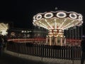 Brightly Illuminated circular carousel on the Kazan Embankment on a summer evening. People ride on the carousel and walk around Royalty Free Stock Photo