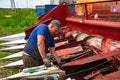 Kazan, Russia. 2022, June 12. A man fixing a combine harvester. Modern agricultural machinery. Royalty Free Stock Photo