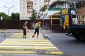 Kazan, Russia, June 2019: Workers make asphalt markings. Road workers draw a zebra - crosswalk Royalty Free Stock Photo