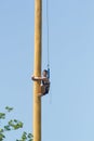 KAZAN, RUSSIA - JUNE 23, 2018: Traditional Tatar festival Sabantuy - A young man climbs on a wooden post at folk tatar Royalty Free Stock Photo