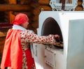 Kazan, Russia. 2022, June 18. A woman cooks traditional flatbread in a Russian stove.