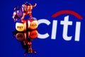 Metal bull stands on buy-sell dices on background of Citigroup logo