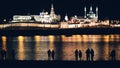 Kazan, Russia, 12 may 2017 - Kazan kremlin with reflection in river at night and silhouettes of people Royalty Free Stock Photo