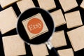 Modified photo of Etsy logo on a box under a magnifying glass surrounded by parcels