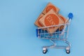 Modified photo of parcel with Etsy logo in the shopping cart on a blue background