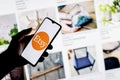 A smartphone with the Etsy logo in a hand Royalty Free Stock Photo