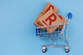 Modified photo of parcel with Rakuten logo in the shopping cart on a blue background