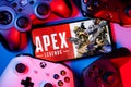 A smartphone with the frame from Apex Legends on the pile of the gamepads Royalty Free Stock Photo