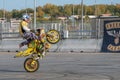 A biker rides on the back wheel of a bike