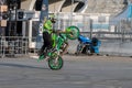 A biker rides on the back wheel of a bike