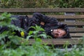 KAZAN, RUSSIA - 9 SEPTEMBER 2017: homeless alcoholic beggar man is sleeping on bench in park