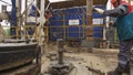 Workers draw out pipe and mount on exploratory drilling machine