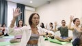 Woman does breathing exercises with training participants