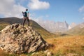 Kazbegi - A man enjoying the panoramic view on the sharp Chaukhi massif in the Greater Caucasus Mountain Range in Georgia.