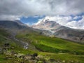 Kazbek mountain. Mountains landscape with snowy peak and green valley. Royalty Free Stock Photo