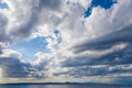 Kea, Tzia island, destination Greece. Silver sunbeams on the sea through clouds background