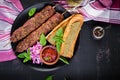 Kebab adana, lamb and beef and toasts with pesto sauce.