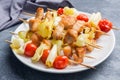 Kebab chicken, zucchini and tomatoes on skewers in a plate. Dark table Royalty Free Stock Photo